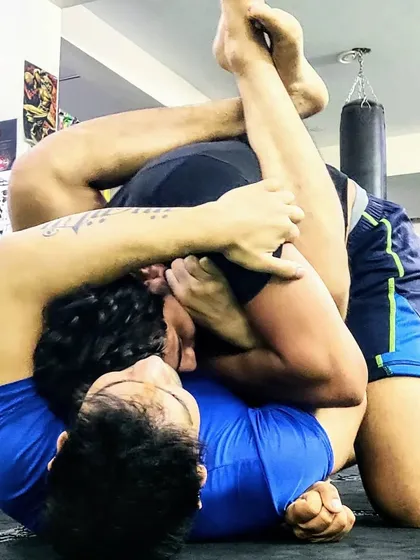 In a real fight, control is everything. I teach the principle of 'position over submission' in my BJJ and grappling classes. Here, we are drilling a triangle choke, focusing on maintaining control before looking for the finish.