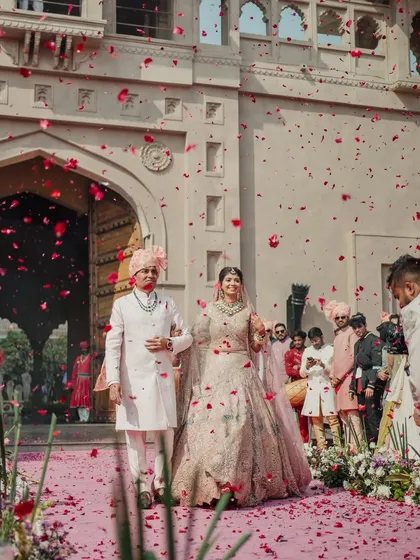 A grand exit from the ceremony, with guests showering the happy couple with rose petals. We plan every detail to make your wedding feel like a fairytale.