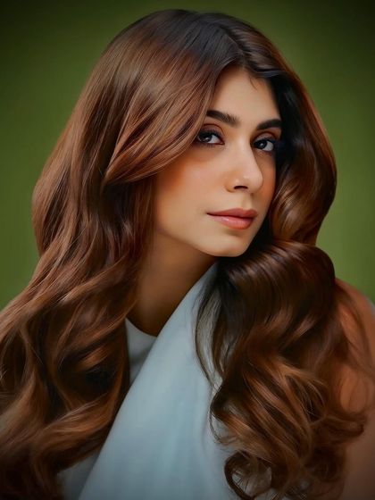 This look from our collection features soft, flowing waves with a warm brown tone that complements the client's skin tone beautifully.