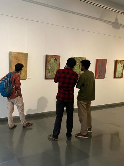 A group of young men studying the detailed paintings.