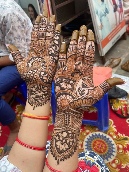 The same bridal mehandi from a slightly different angle, highlighting the fine details on the fingers and the wrist.