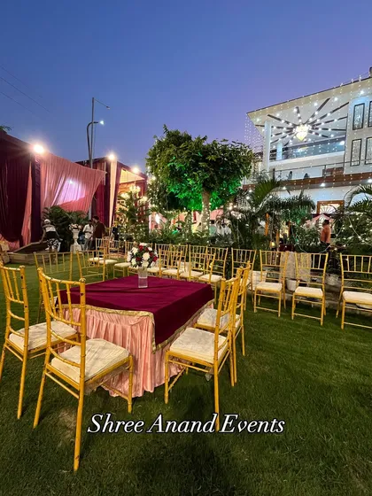 A simple yet elegant outdoor seating arrangement with gold chiavari chairs, perfect for a smaller gathering or ceremony.