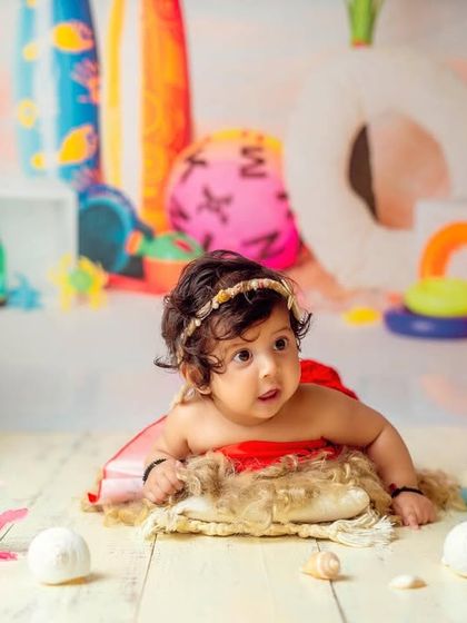 Tummy time on the beach. This is another adorable pose from our tropical Moana-themed session.
