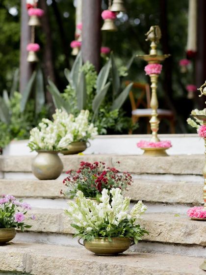 A closer look at the floral and brass decor on the stone steps, adding elegance to the ceremony.