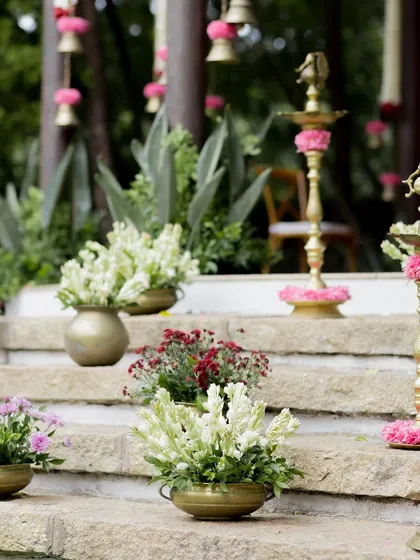 Close-up of the decor details, with brass pots of flowers and traditional lamps lining the steps.