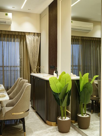 This dining console is beautifully designed with intricate details. The shutters are finished in a grooved HDHMR sheet with a PU finish to achieve a more seamless look, while the top is finished in a marble-look acrylic laminate.