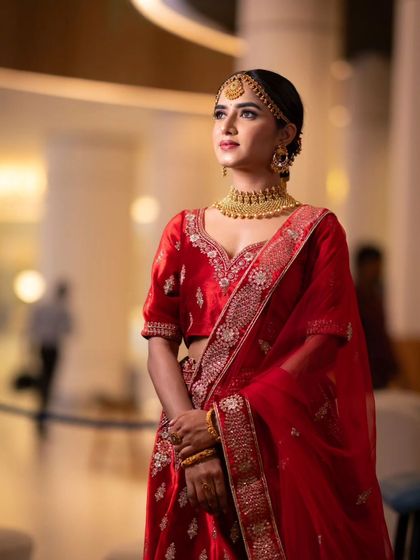 A medium shot showing the intricate embroidery on the lehenga and the complementary makeup.