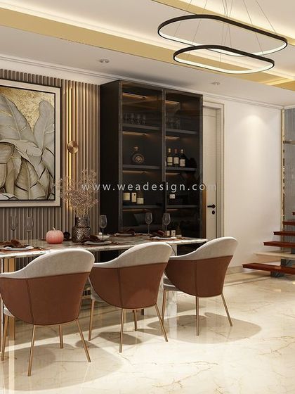 An open-plan view of the penthouse, showing the dining area, living space, and staircase, all designed with a cohesive luxury aesthetic.