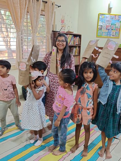 Our little monkeys. The children have fun with the paper bag monkey masks they created after the story, extending the play and imagination.