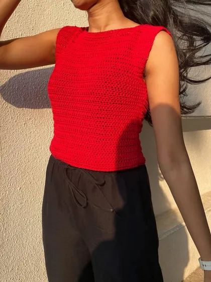 The bright red crochet top is perfect for making a statement. It's lightweight and breathable for warm summer days.