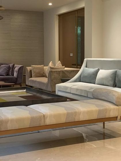 A detail of the living room, showing the custom daybed and curved sofa. The mix of subtle patterns and soft velvets creates a space that is both sophisticated and deeply comfortable.