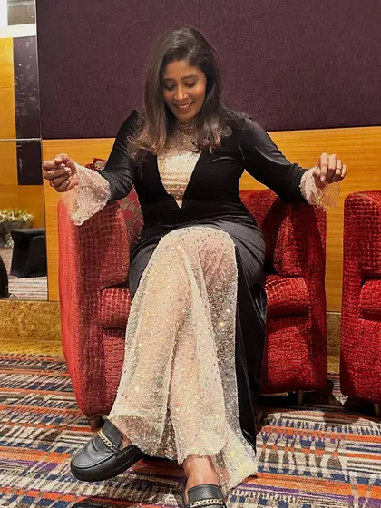 A candid moment of relaxation after a show. Even in my formal wear, I value comfort. It's about finding the balance between powerful elegance and being true to myself.