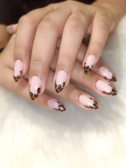 A classic French manicure, but make it fierce. I gave this timeless look a modern twist with hand-painted leopard print on the tips of these almond-shaped extensions.