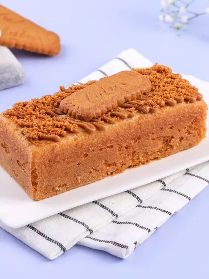 The Lotus Biscoff Teacake, looking perfectly golden and ready to be sliced. You can see the layer of Biscoff spread and biscuit crumbs on top.
