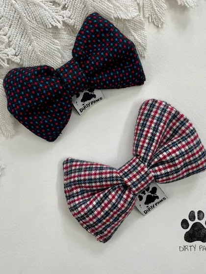 Two classic print bows, one with polka dots and one with plaid. These timeless designs are perfect for a dapper dog.