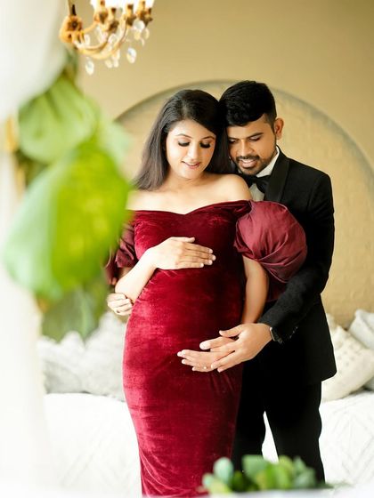 A close-up, intimate moment between the expecting parents, filled with love and anticipation for their growing family.