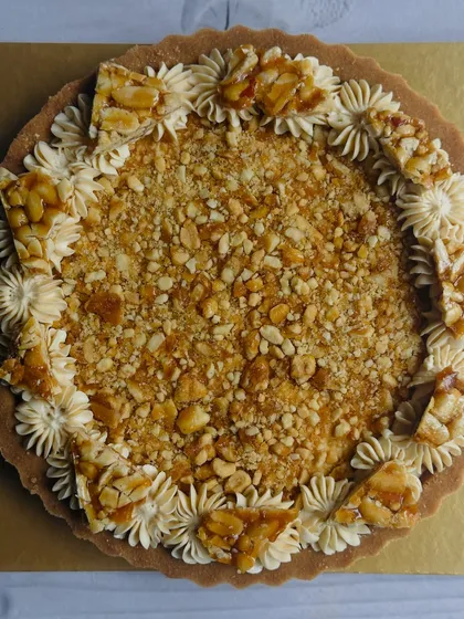 For Makar Sankranti, I make this Chikki-Top Peanut Butter Tart. It has a rich peanut butter cheesecake filling and is crowned with a crunchy, caramelized peanut chikki topping.