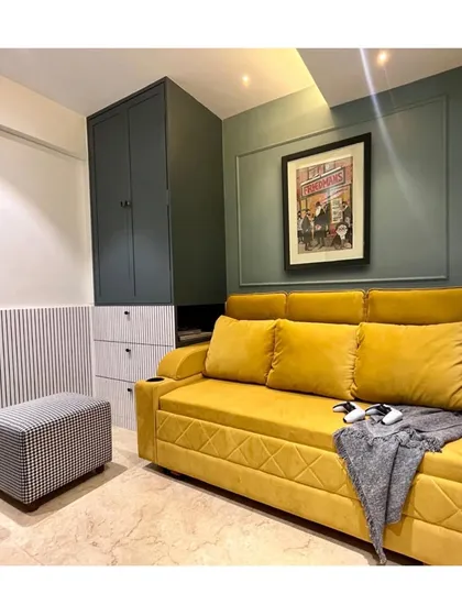 The entertainment room is personalized with framed art, including a piece celebrating a love for motorsports. We believe in creating spaces that reflect our clients' passions.