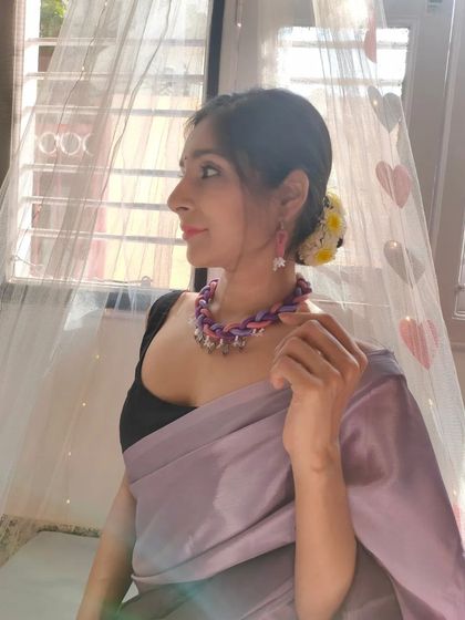 Here I am modeling the braided thread necklace, showing how it can elevate a simple saree. The combination of colors and textures makes it a versatile accessory.