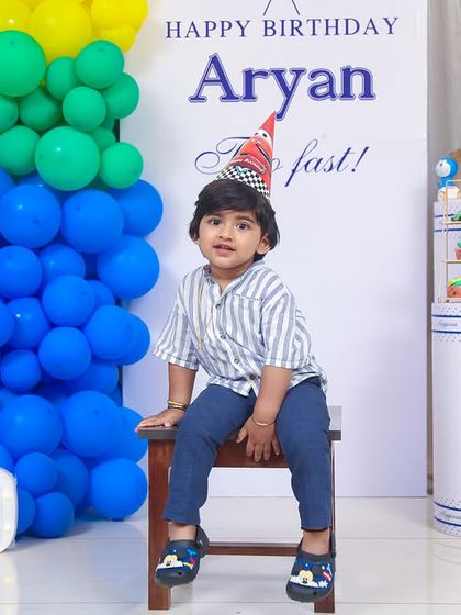 A thrilling 'Avengers' themed birthday party, with superhero cutouts, a cityscape backdrop, and dynamic balloon arrangements, ready for action.