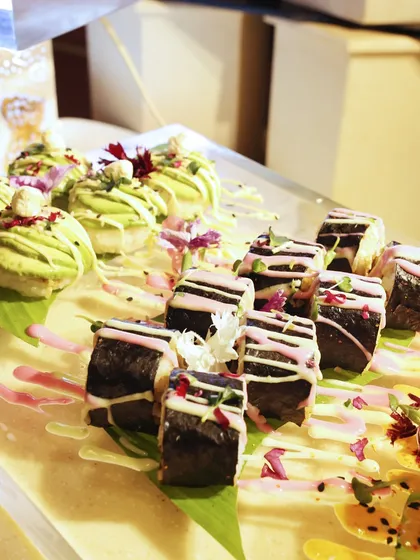 A colourful assortment of our creative sushi rolls, featuring avocado wasabi bites and pink-striped maki. This is sushi that dares to be different.