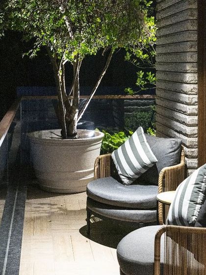 A quiet evening on the balcony of the Barkat residence. We design these outdoor spaces as true extensions of the home, with comfortable seating and thoughtful planting that create a serene atmosphere for relaxation.