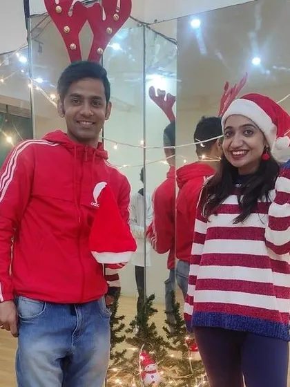 Two of our instructors getting into the holiday spirit during the Christmas party, complete with festive props and a decorated tree in the background.