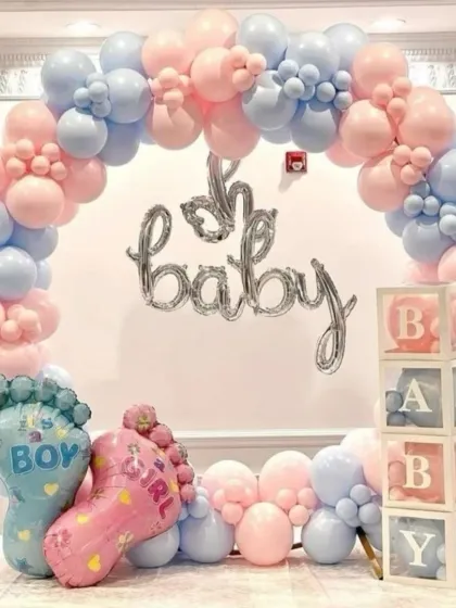 A fun and festive gender reveal balloon arch in classic pink and blue. This setup includes 'Oh Baby' foil balloons, 'BABY' blocks, and giant baby feet foil balloons for a playful announcement.