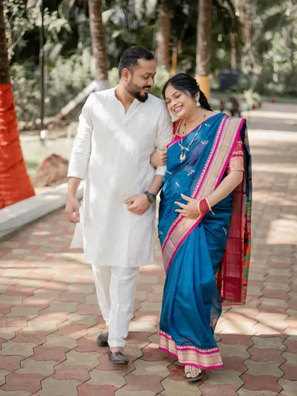 A candid moment of the happy couple during their baby shower celebration. Dressed in traditional attire, their shared joy and excitement are what make these event photos so special.