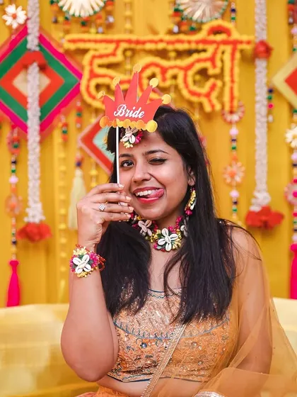 A playful and cheeky moment from the bride during her haldi, showing off her fun personality.