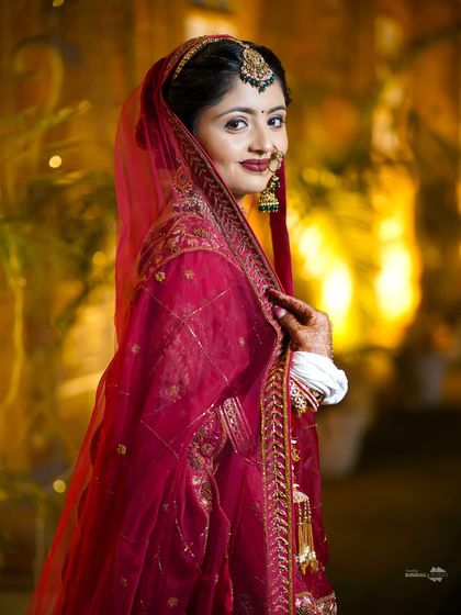A classic, elegant bridal portrait. The bride's soft smile and the warm, glowing background create a timeless and beautiful image.