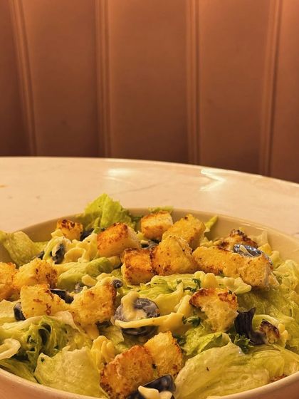 A Caesar salad with croutons. A classic choice that can be made healthier with a light dressing.