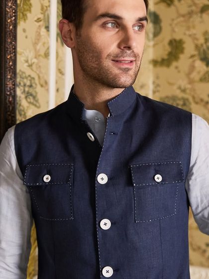 A close-up on the Hunter Waistcoat, highlighting the detailed stitching and the quality of the linen fabric. It's a piece that embodies crafted confidence.