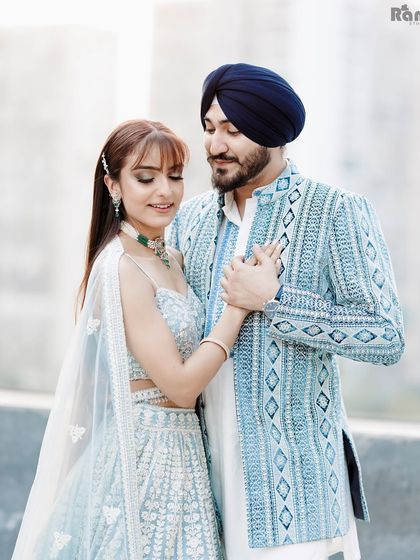 A tender moment between a couple, captured in a simple, elegant setting. The groom's gentle touch and their soft expressions make this a heartwarming and classic engagement portrait.