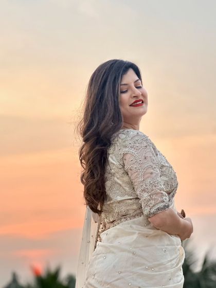 A serene, eyes-closed shot. This captures the peaceful moment and highlights the soft, romantic feel of the makeup and hairstyle.