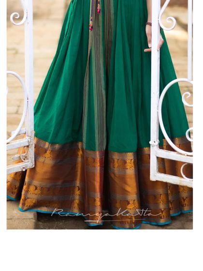 The rich texture of the jade green dress with its traditional gold border provides a beautiful contrast to the modern embroidered jacket.