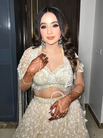 A final shot showing the complete look, from the sparkling outfit to the flawless makeup.