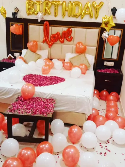 This view highlights the balloons scattered on the floor and the rose petals on the side table, showing how I use every part of the room to create a festive feel.