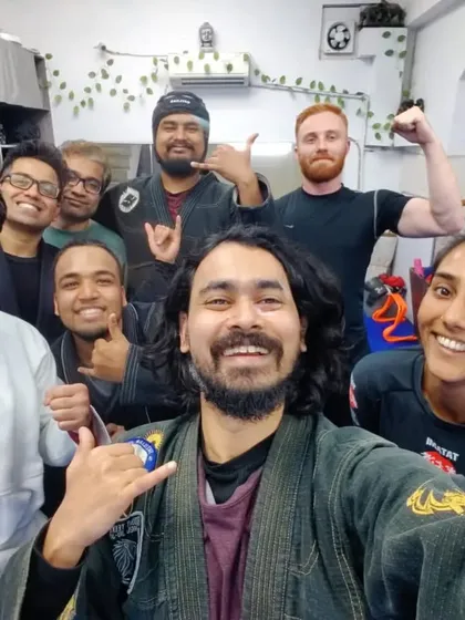 Post-training glow. Our members, a mix of beginners and experienced practitioners, sharing a moment of achievement.