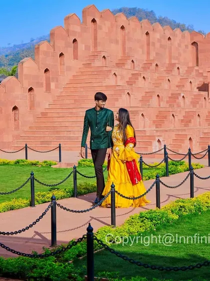 A quiet walk along the path of our palace grounds. This shot, framed through an archway, adds a sense of intimacy and storytelling to the pre-wedding album.