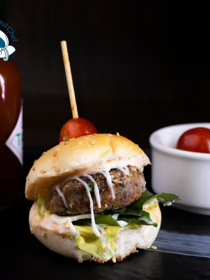 Mini burgers are a fun and satisfying choice for any informal event. I offer various patties, including this charcoal mini veg burger, served on a soft bun with lettuce and a special sauce.