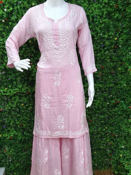 A soft pink Chikankari kurti and sharara set. This unstitched material allows for full customization, perfect for creating a graceful and traditional outfit for festive occasions.