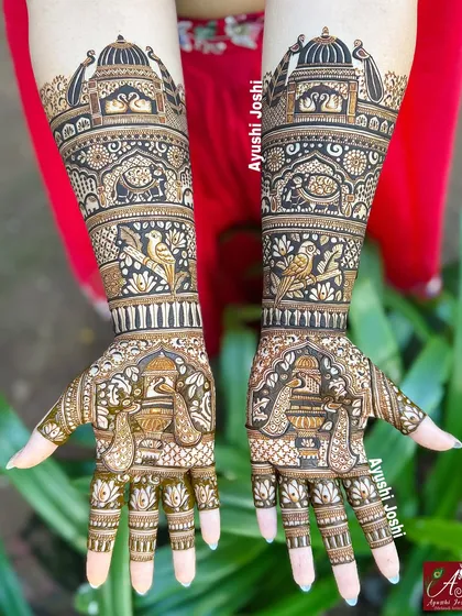 An engagement mehendi that's all about royal elegance. This design is packed with traditional Indian motifs, including temple domes, love birds, peacocks, and swans, creating a rich and intricate look for the special day.