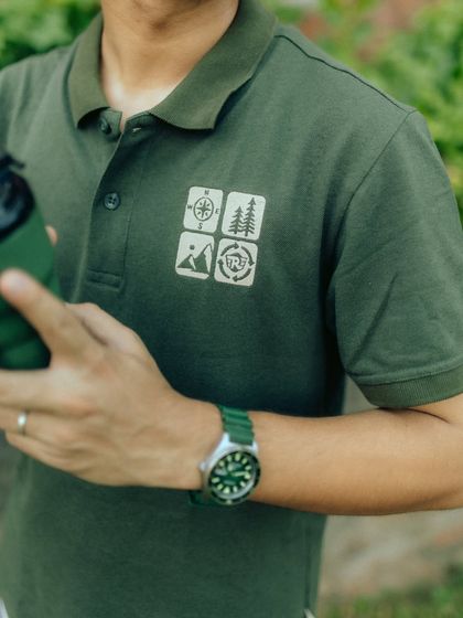 A close-up on the polo shirt's graphic details and accessories. This shot is important for showcasing product quality and design elements that matter to customers.