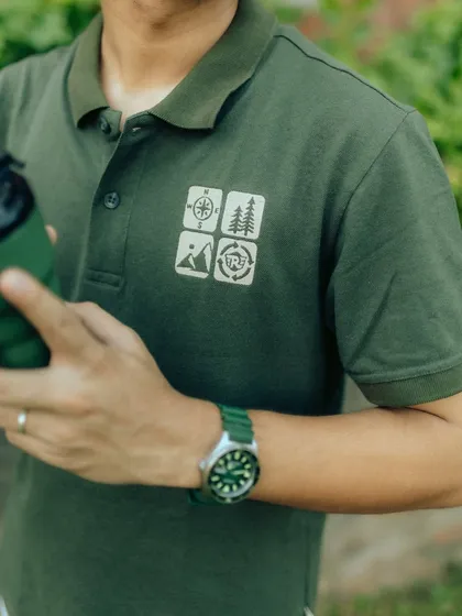 A close-up on the polo shirt's graphic details and accessories. This shot is important for showcasing product quality and design elements that matter to customers.