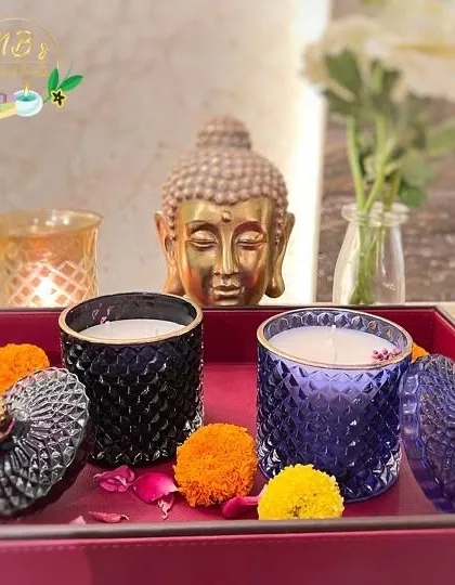 My crystal jar candles look beautiful when styled in your home. Here, the black and purple jars are set on a tray with marigold flowers, creating a serene and festive atmosphere perfect for Diwali.