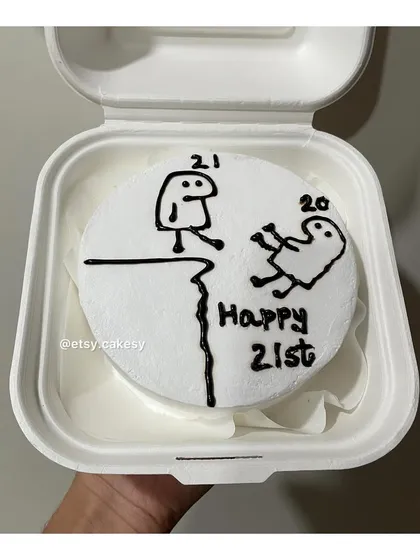 A funny meme-inspired bento cake for a 21st birthday, showing a character pushing another off a cliff from '20' to '21'.