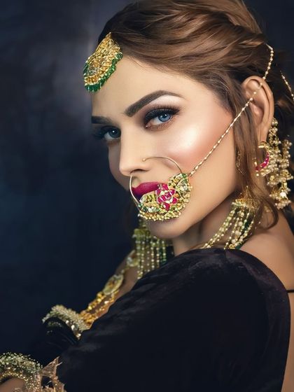 This celebrity-style look is all about high-impact glamour. The eyes are the focus, with a dramatic wing and full lashes, balanced by a perfectly applied bold lip.