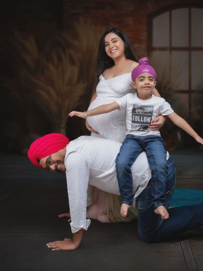 Moments like these capture the heart of family. A playful dad, a spirited child, and a mom-to-be glowing with joy and anticipation.