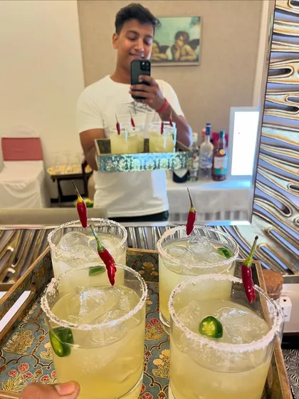 A tray of our popular Picante cocktails, ready to be served. We focus on perfectly balanced flavors using fresh ingredients, like the jalapeno and coriander in this tequila-based drink, to create cocktails that are both delicious and memorable.